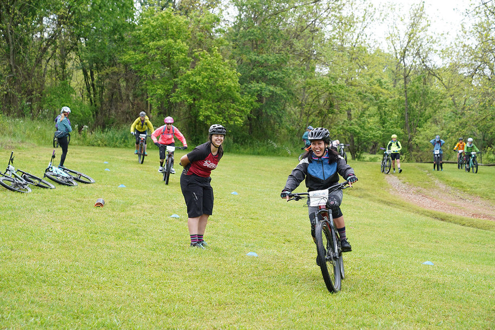 Women riding bikes and rehydrating with Ultima Replenisher