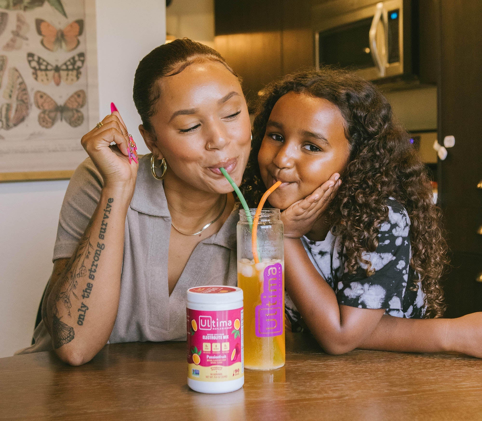 Mother and daughter share a delicious and replenishing drink of Ultima, sugar-free free electrolyte powder
