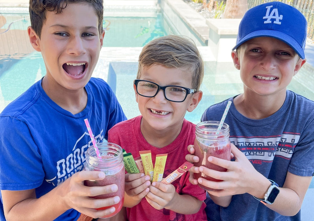 Three boys enjoying a Strawberry Peach Digestive Tonic made with Ultima Replenisher