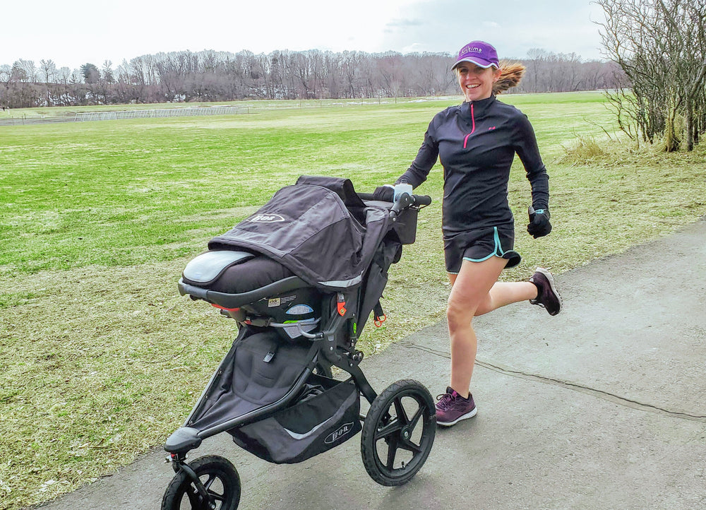 Woman running with stroller and staying hydrated with Ultima Replenisher electrolyte mix