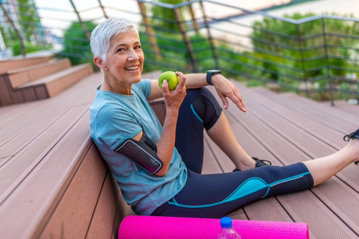 woman eating an apple after exercise