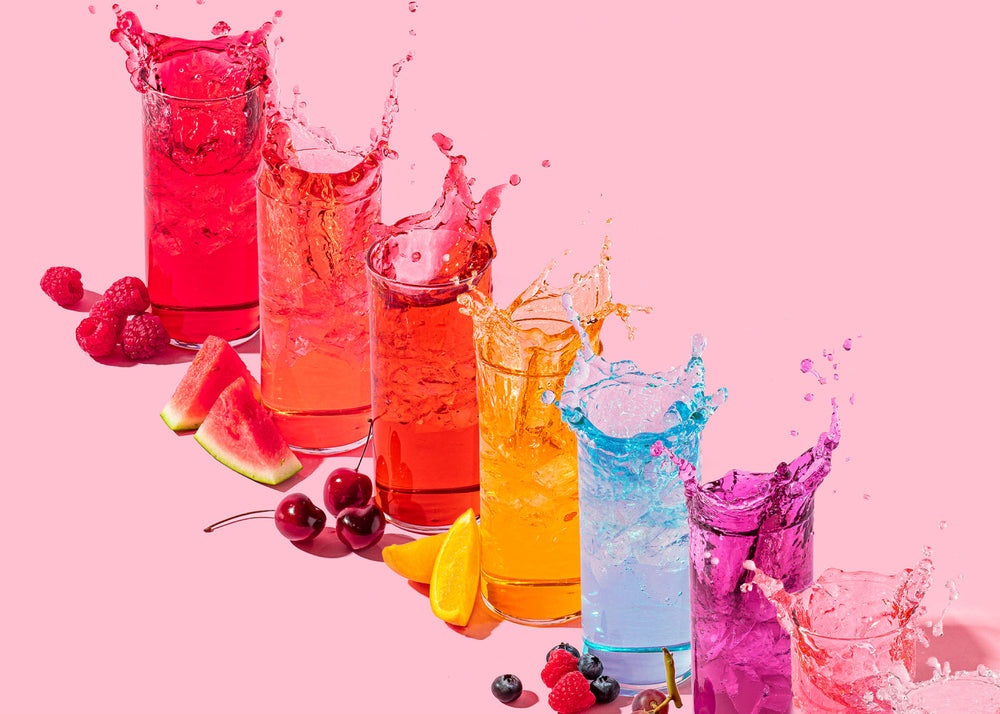 Rainbow of flavors for Ultima Replenisher splashing out of glasses