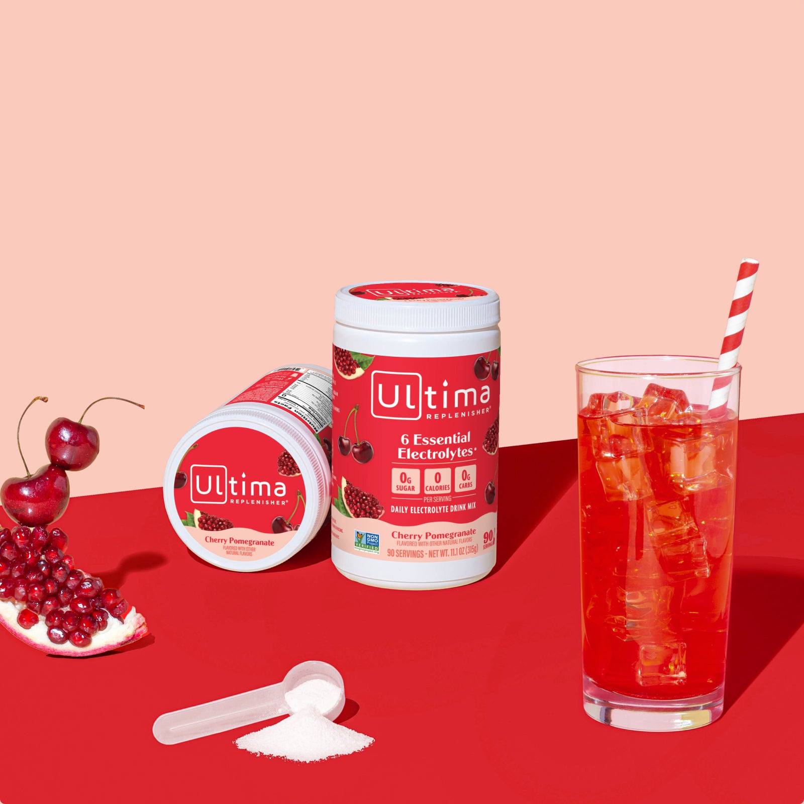 Ultima Replenisher Cherry Pomegranate electrolyte hydration powder 90 serving canister lifestyle with glass and fruit