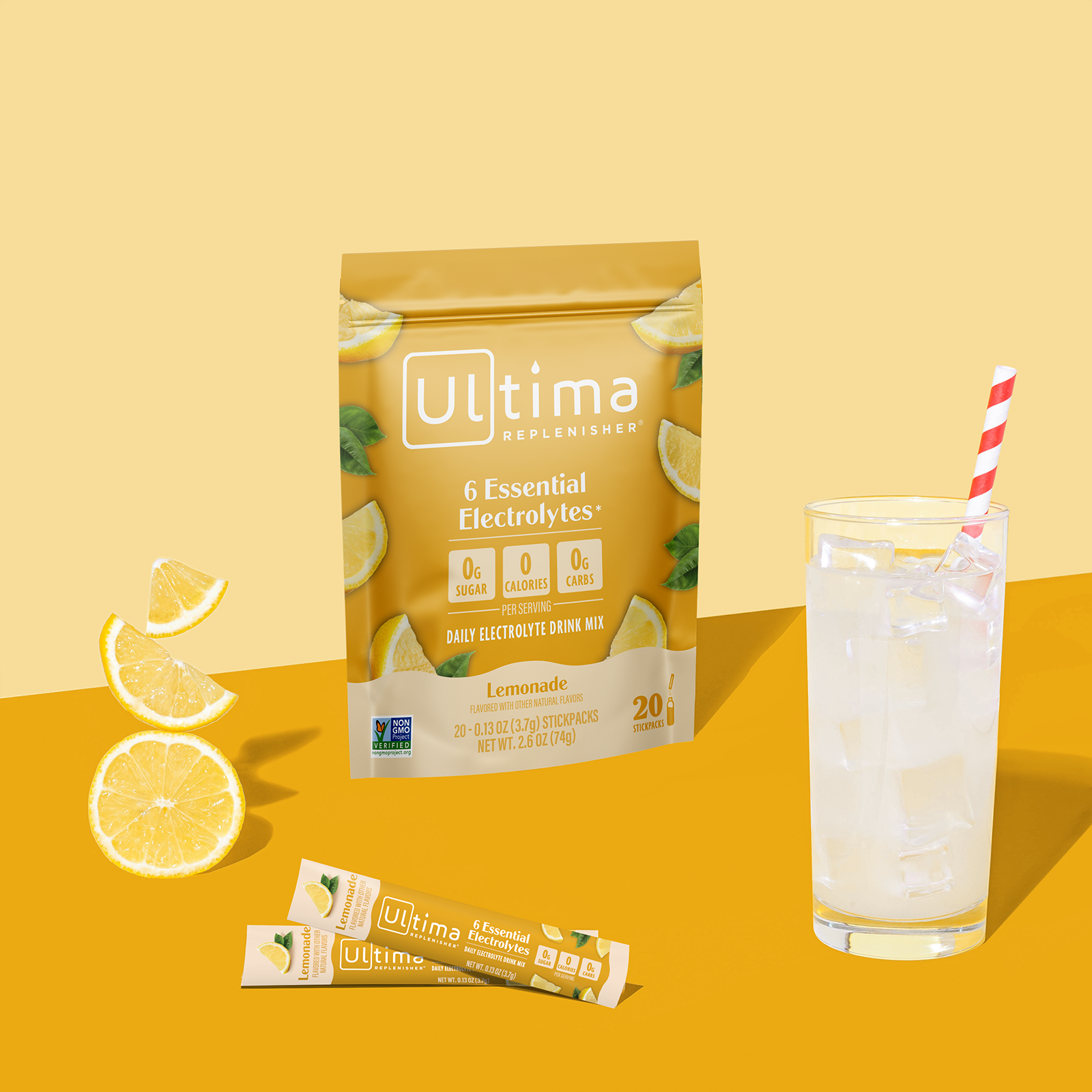 Ultima Replenisher Lemonade electrolyte hydration powder pouch lifestyle with glass and fruit
