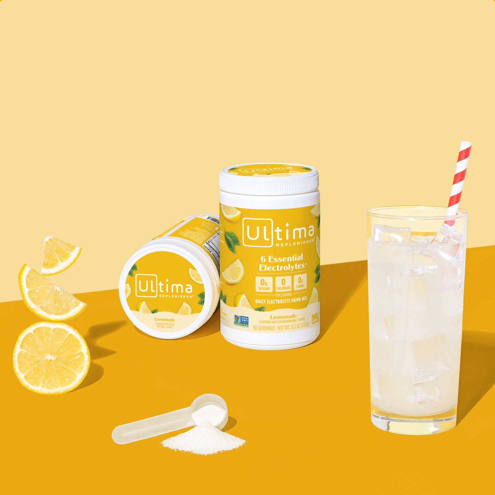 Ultima Replenisher Lemonade electrolyte hydration powder 90 serving canister lifestyle with glass and fruit