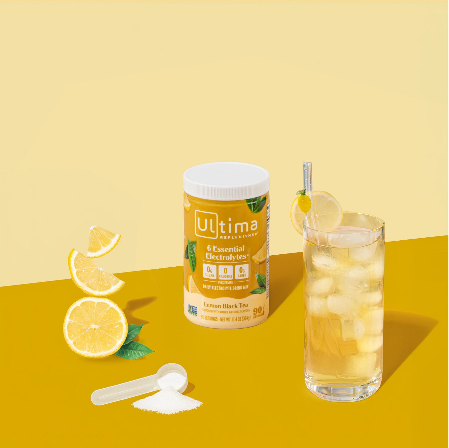 Ultima electrolyte powder container with a glass of lemonade on a yellow background