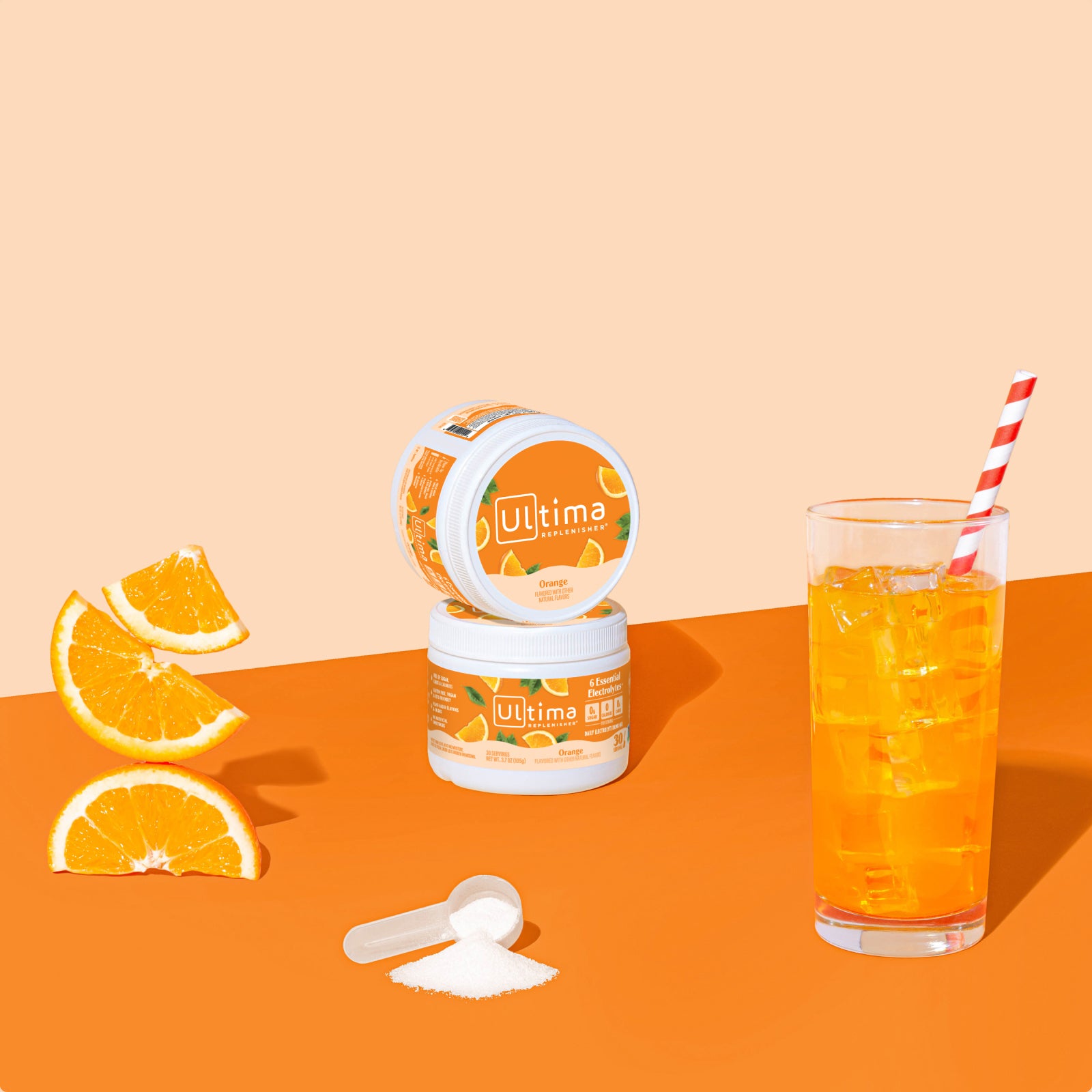 Ultima Replenisher Orange electrolyte hydration powder 30 serving canister lifestyle with glass and fruit