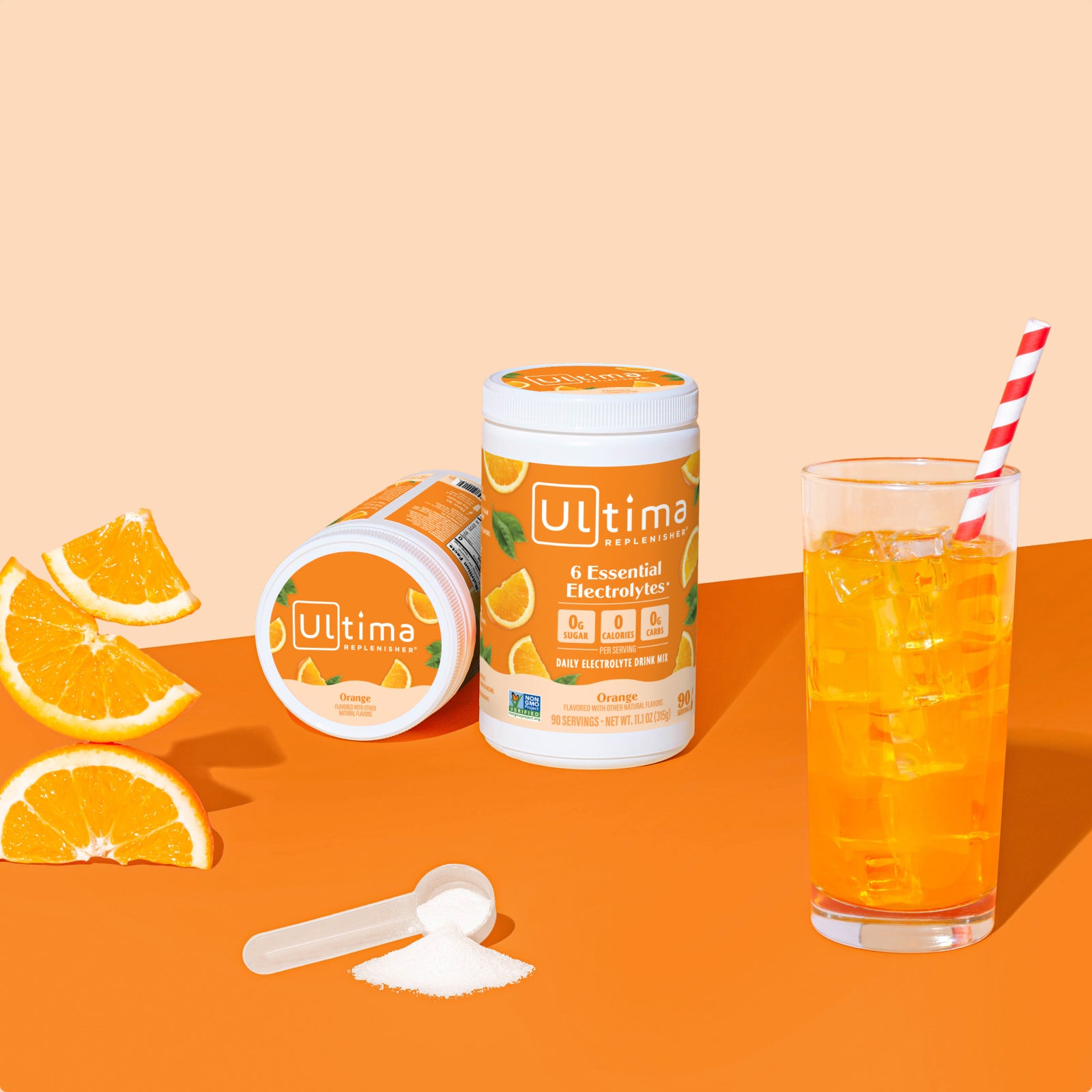 Ultima Replenisher Orange electrolyte hydration powder 90 serving canister lifestyle with glass and fruit