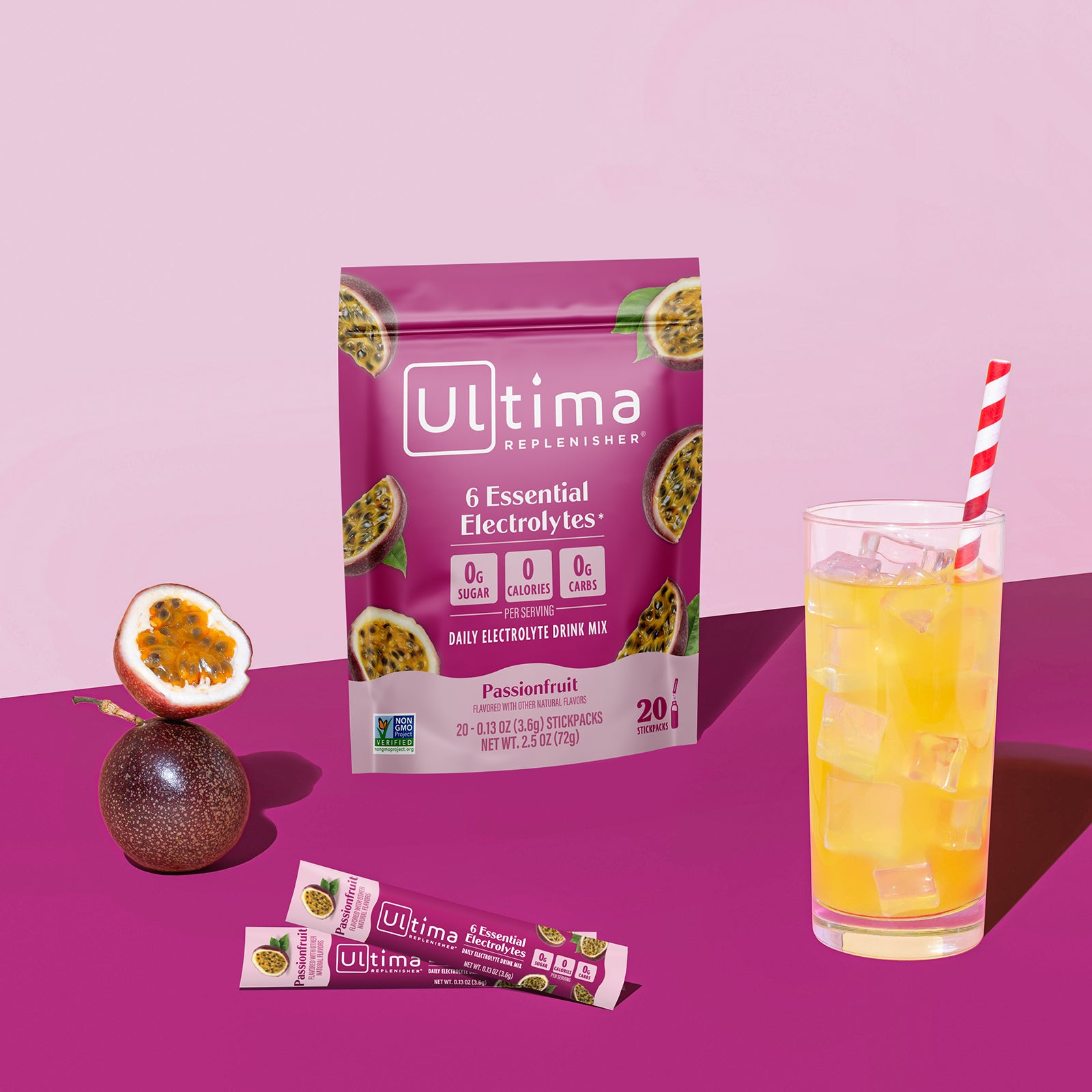 Ultima Replenisher Passionfruit electrolyte hydration powder pouch lifestyle with glass and fruit