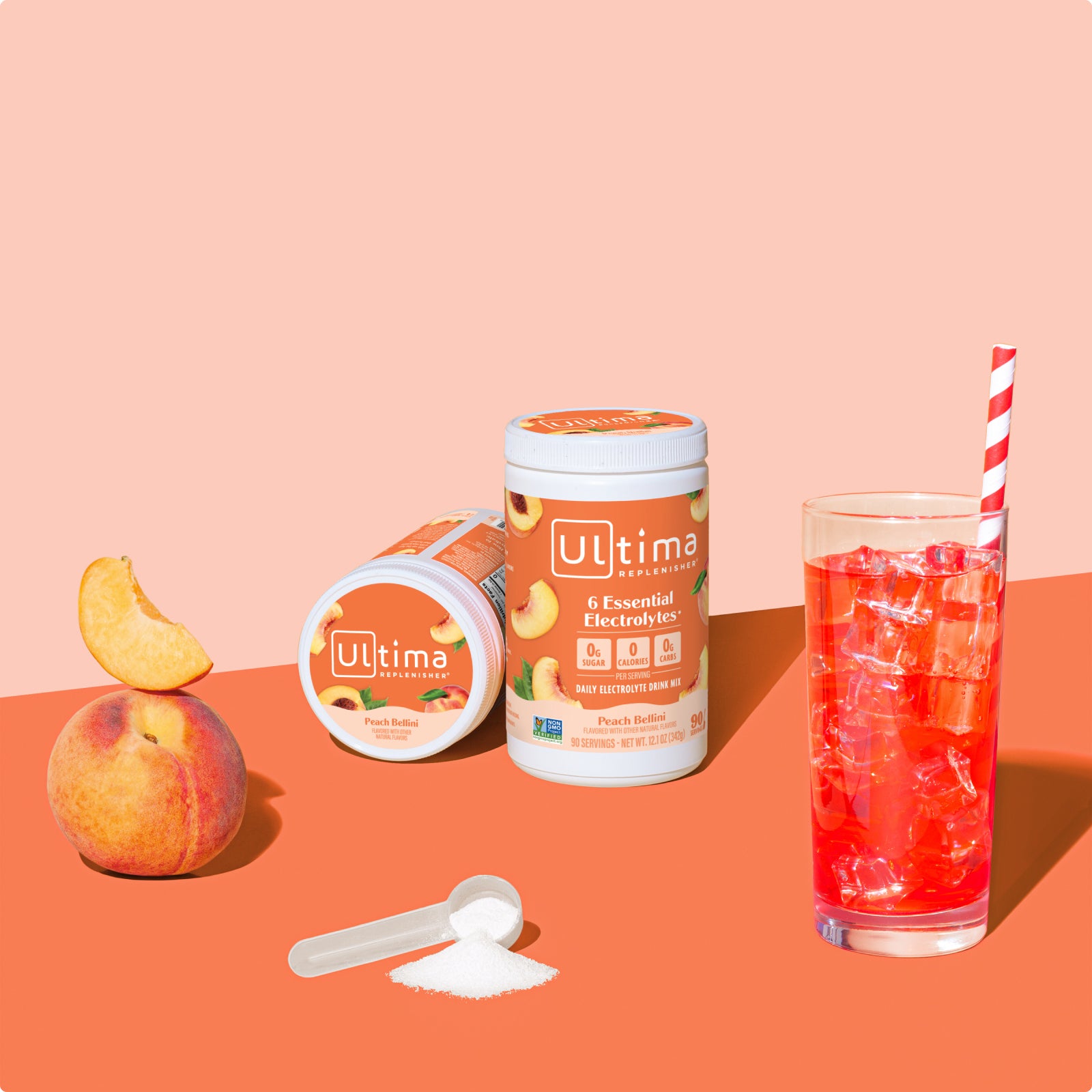 Ultima Replenisher Peach Bellini electrolyte hydration powder 90 serving canister lifestyle with glass and fruit