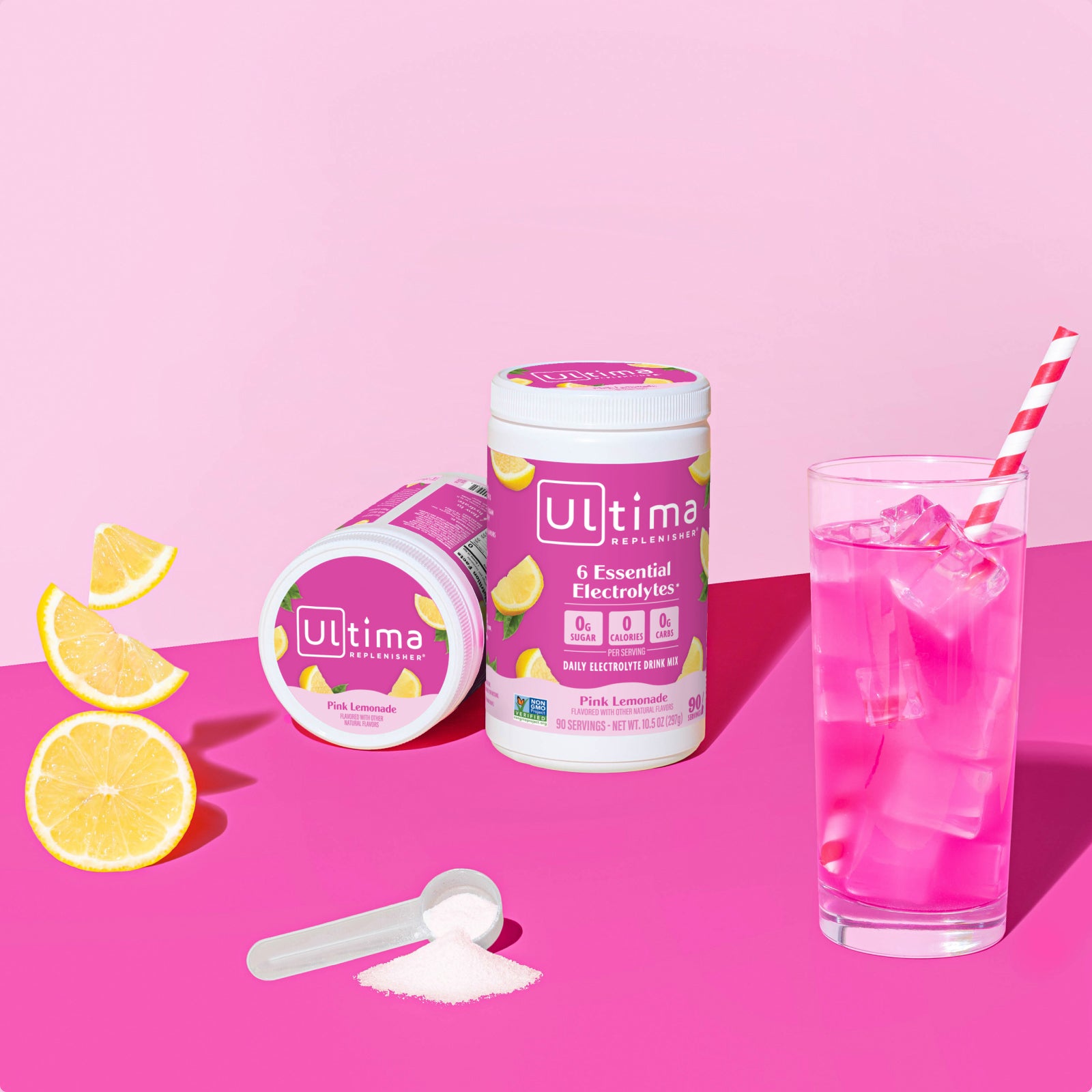 Ultima Replenisher Pink Lemonade electrolyte hydration powder 90 serving canister lifestyle with glass and fruit