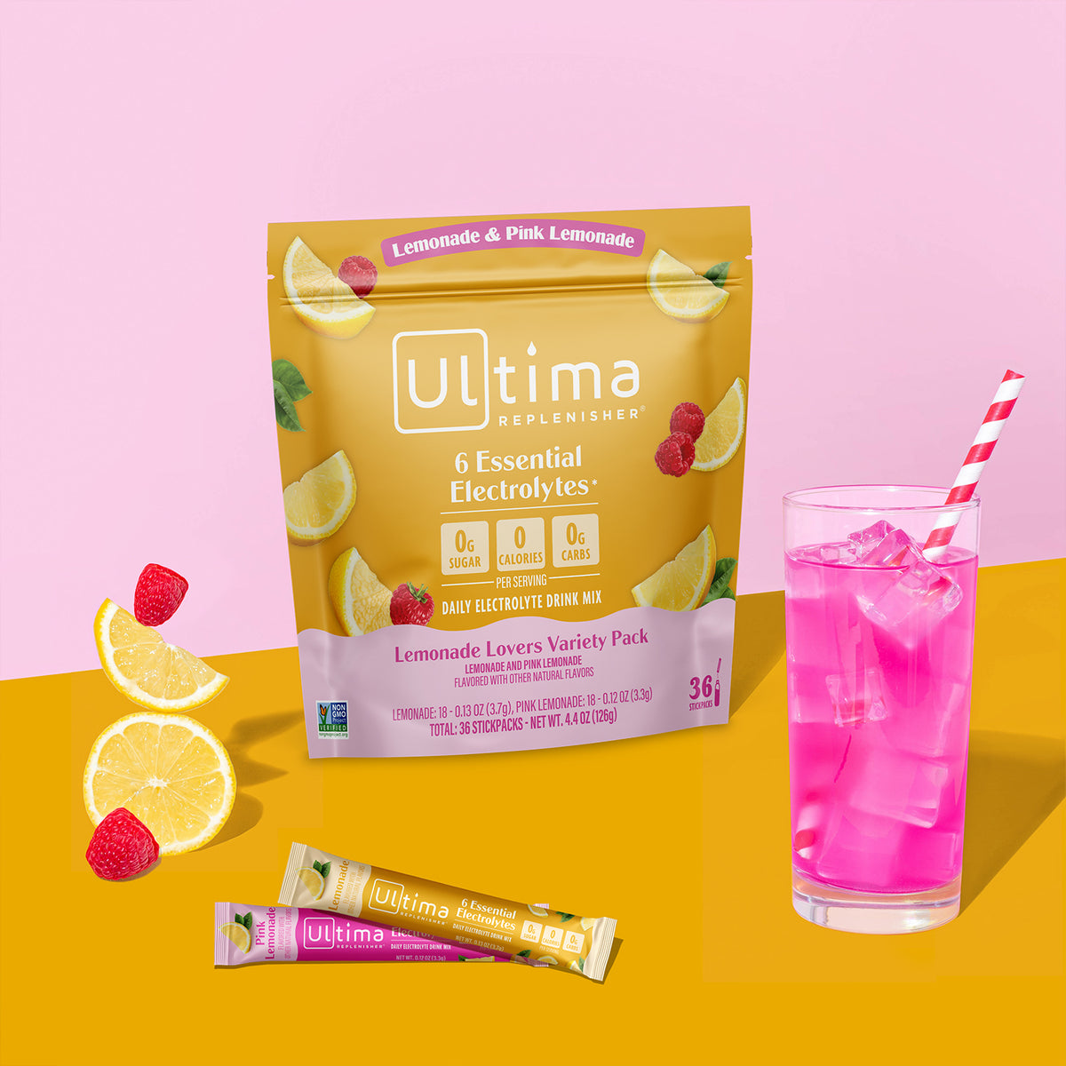 Ultima Replenisher lemonade electrolyte drink mix pouch in a yellow stand-up bag with lemon and raspberry illustrations, shown on a pink and yellow background with a glass of bright pink iced drink, raspberries, and two single-serve sticks.