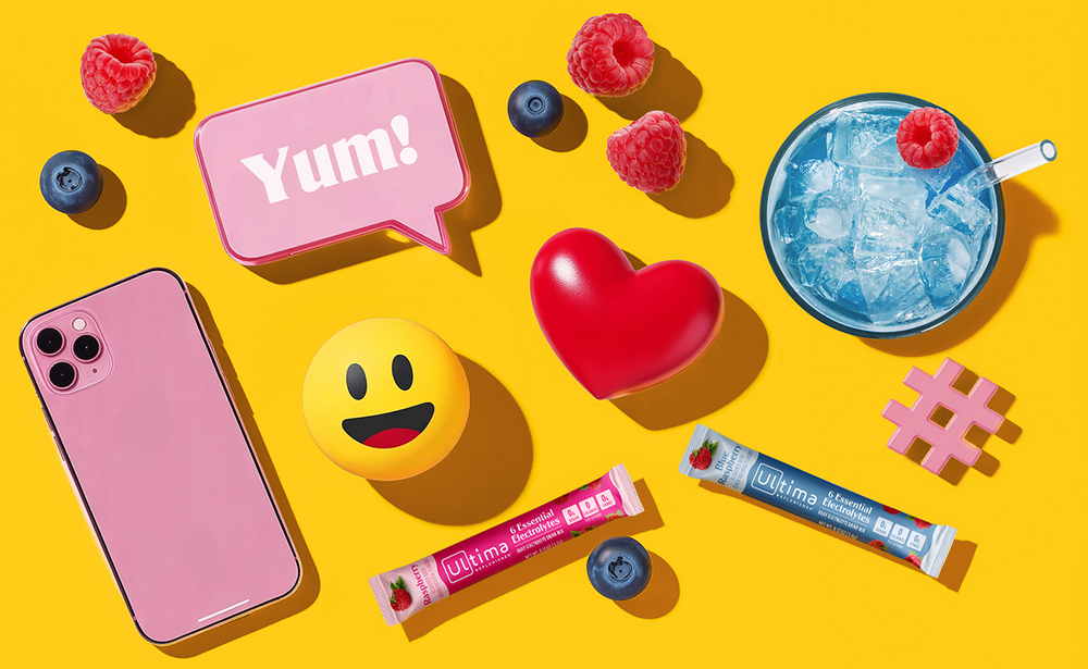 Cell phone, smile icon, and delicious drink on a yellow background